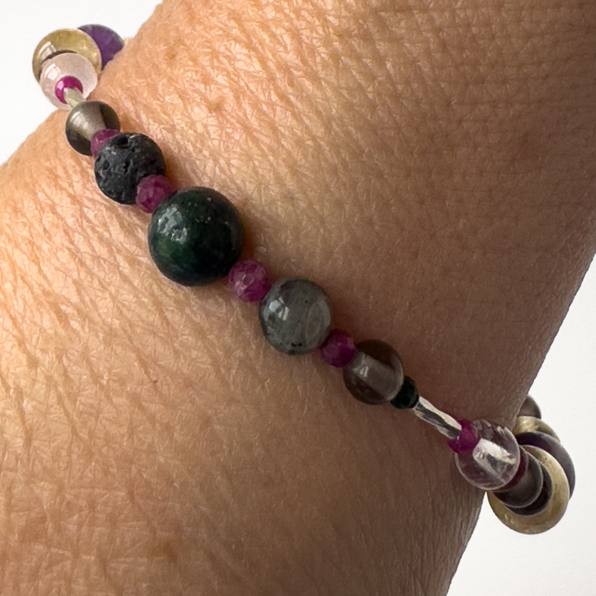 Sagittarius Healing Crystal bracelet for Grief & Loss on wrist showing Azurite, Labradorite, Smoky Quartz, Sugilite, Malachite and Lava Stone