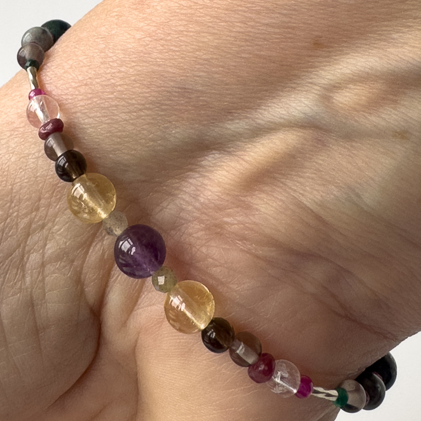 Sagittarius Healing Crystal bracelet for Grief & Loss on wrist showing Citrine, Amethyst, Labradorite, Ruby, Smoky Quartz, and Clear Quartz