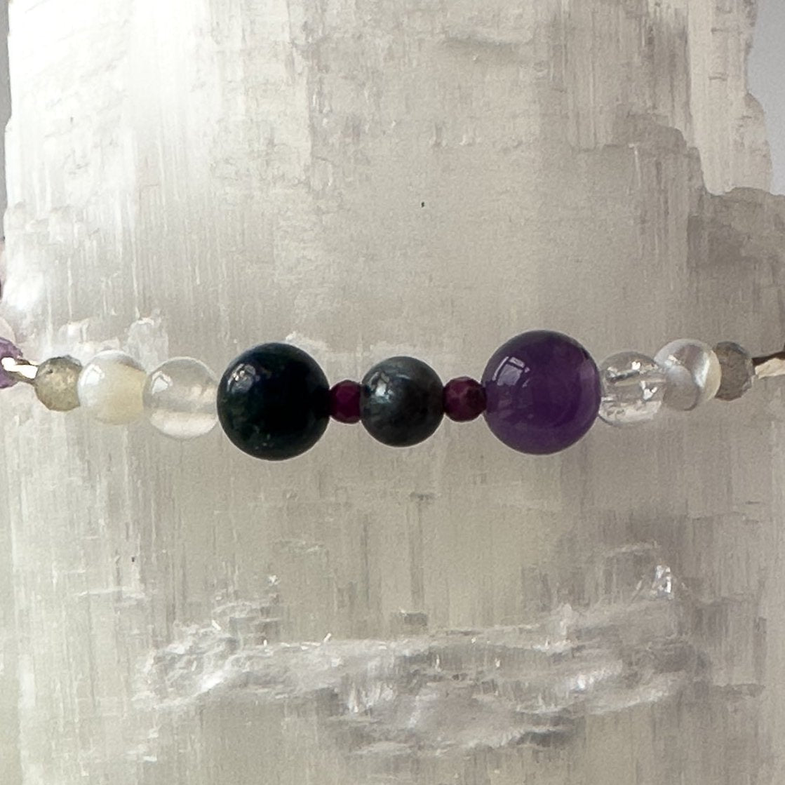 Close-up of Healing crystal bracelet showing Amethyst, Sugilite, Moonstone, Labradorite, Azurite and Clear Quartz