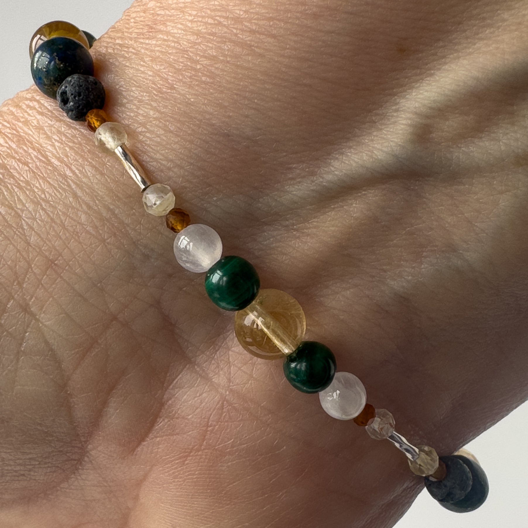 Sagittarius Healing Crystal bracelet for Love on wrist showing Citrine, Garnet, malachite and Selenite