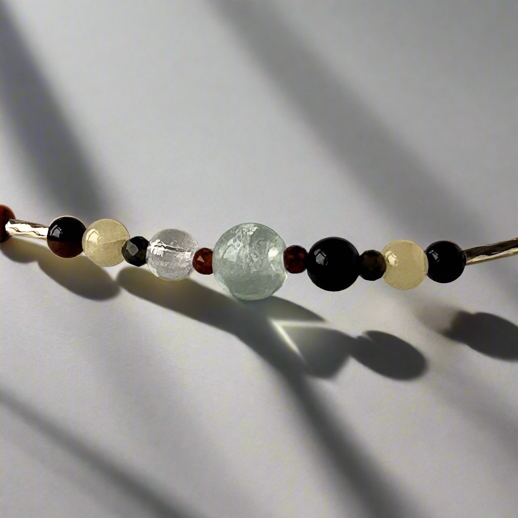 Capricorn Healing Crystal bracelet for Confidence showing Garnet, Mahogany Obsidian, Onyx, Fluorite, Aragonite and Clear Quartz