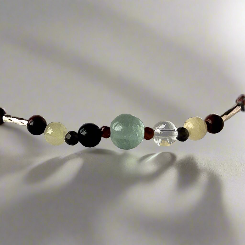 Capricorn Healing Crystal bracelet for Confidence showing Garnet, Obsidian, Mahogany Obsidian, Onyx, Fluorite, Aragonite and Clear Quartz