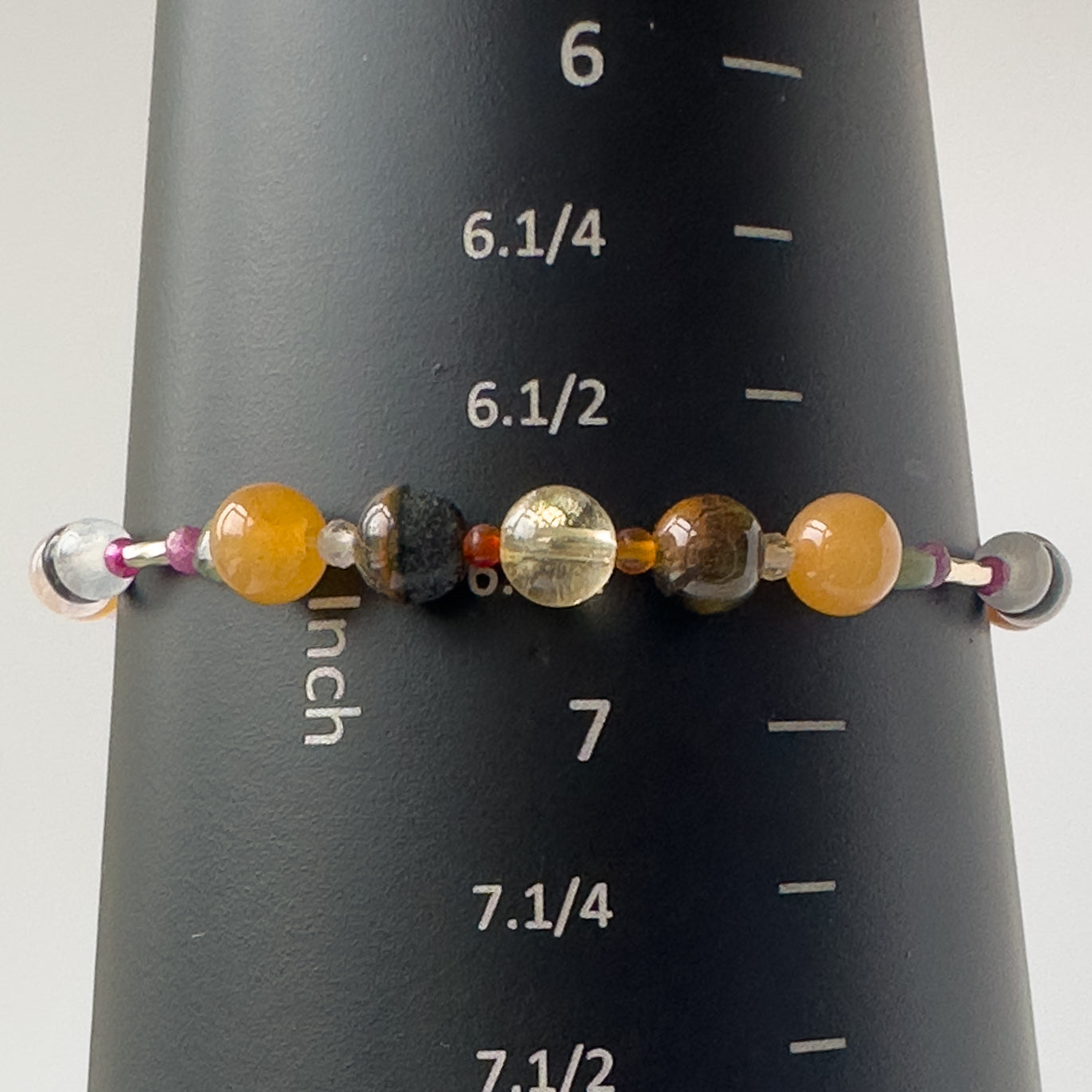 Leo Birthstone Healing Crystal bracelet for Grief & Loss support on mandrel showing a size of 6.75 inches
