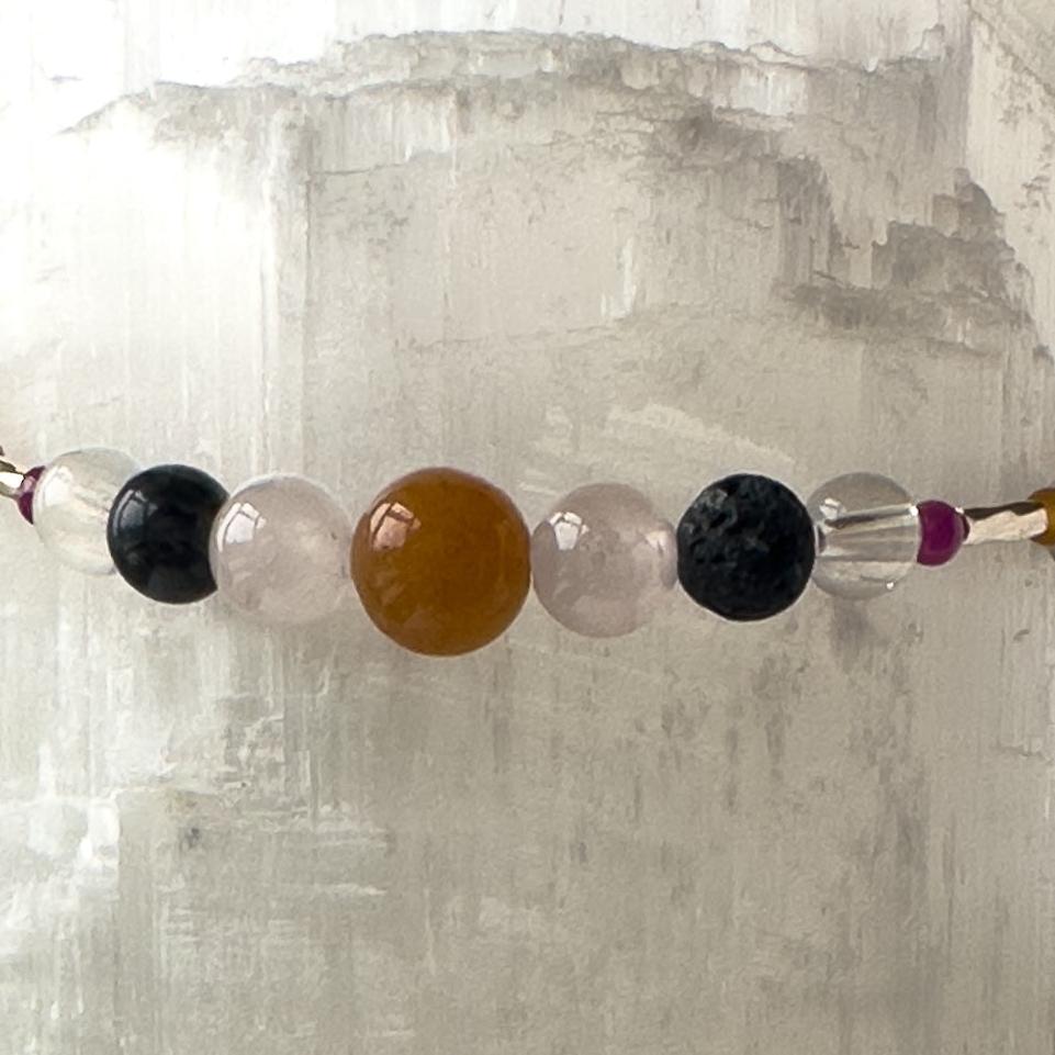 Leo birthstone Healing Crystal bracelet for Grief & Loss support showing Ruby, Black Onyx, Rose Quartz, Carnelian, Selenite, Clear Quartz and Lava Stone