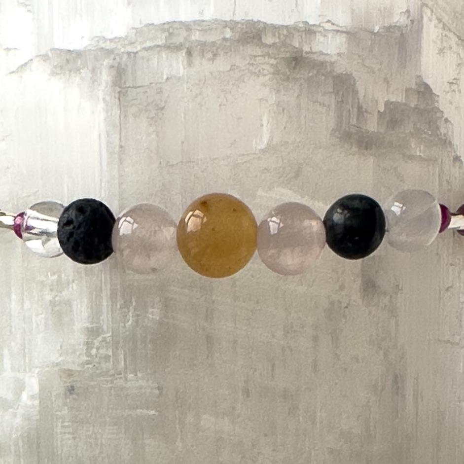 Leo Birthstone Healing Crystal bracelet for Grief & Loss support showing Ruby, Blue Tiger’s Eye, Black Onyx, Rose Quartz, Carnelian, Selenite and Clear Quartz