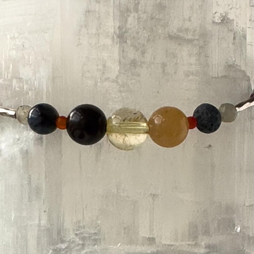 Libra Birthstone Healing Crystal bracelet for Grief & Loss support showing Sugilite, Blue Tiger’s Eye, Citrine, Labradorite, Carnelian and Lava Stone