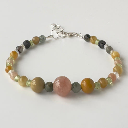 Beaded bracelet with multicolored stones on a white background