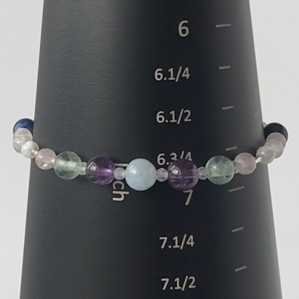 Aquarius Healing Crystal bracelet for Anxiety Close up showing Amethyst, Aquamarine, Fluorite and Rose Quartz on mandrel showing size as 6.75 inches