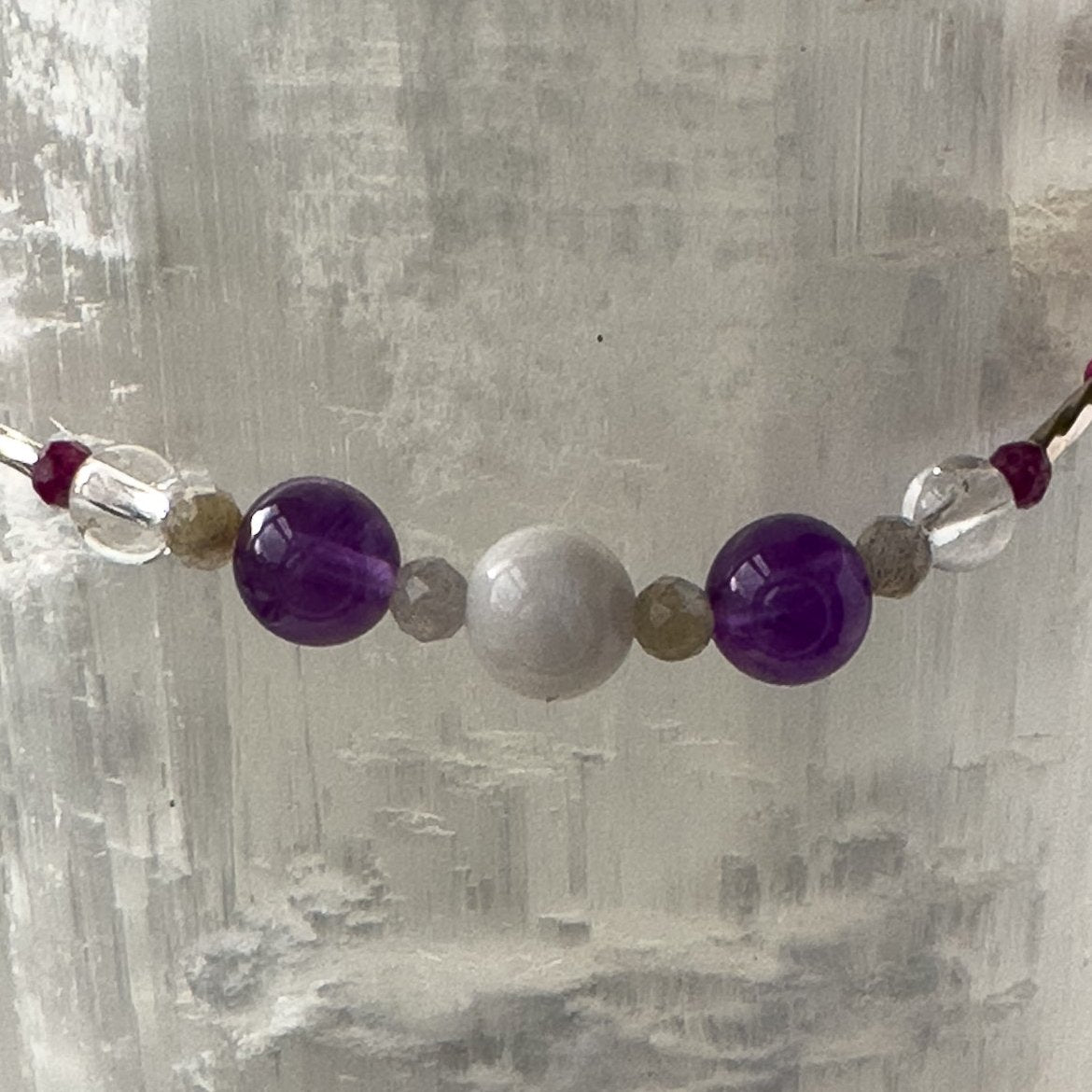 Pisces Birthstone Healing Crystal bracelet for Grief & Loss support showing Amethyst, Labradorite, Moonstone, Ruby and Clear Quartz