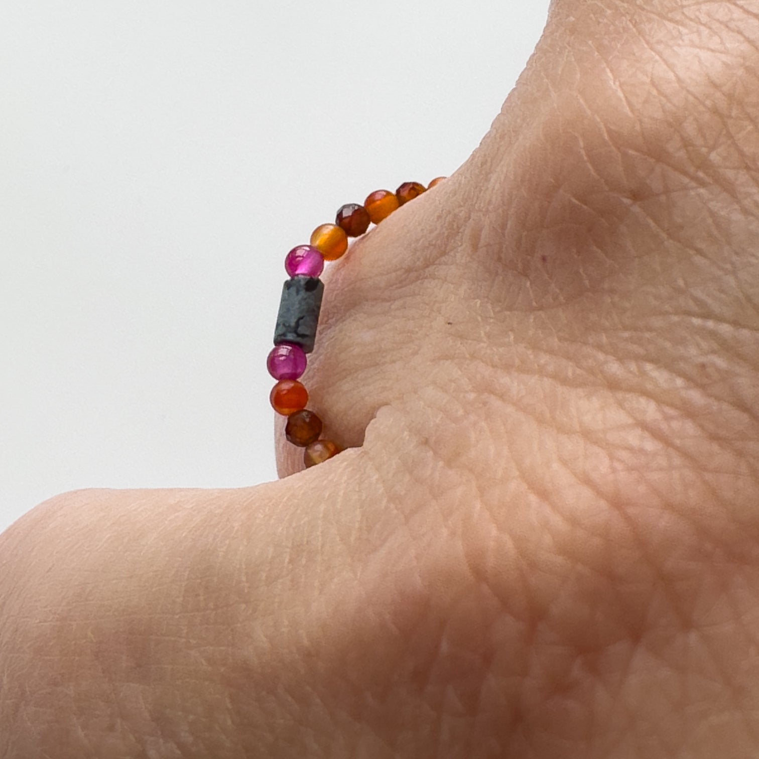 Profile view of Capricorn Birthstone Healing Crystal ring for Strength and Courage on a finger