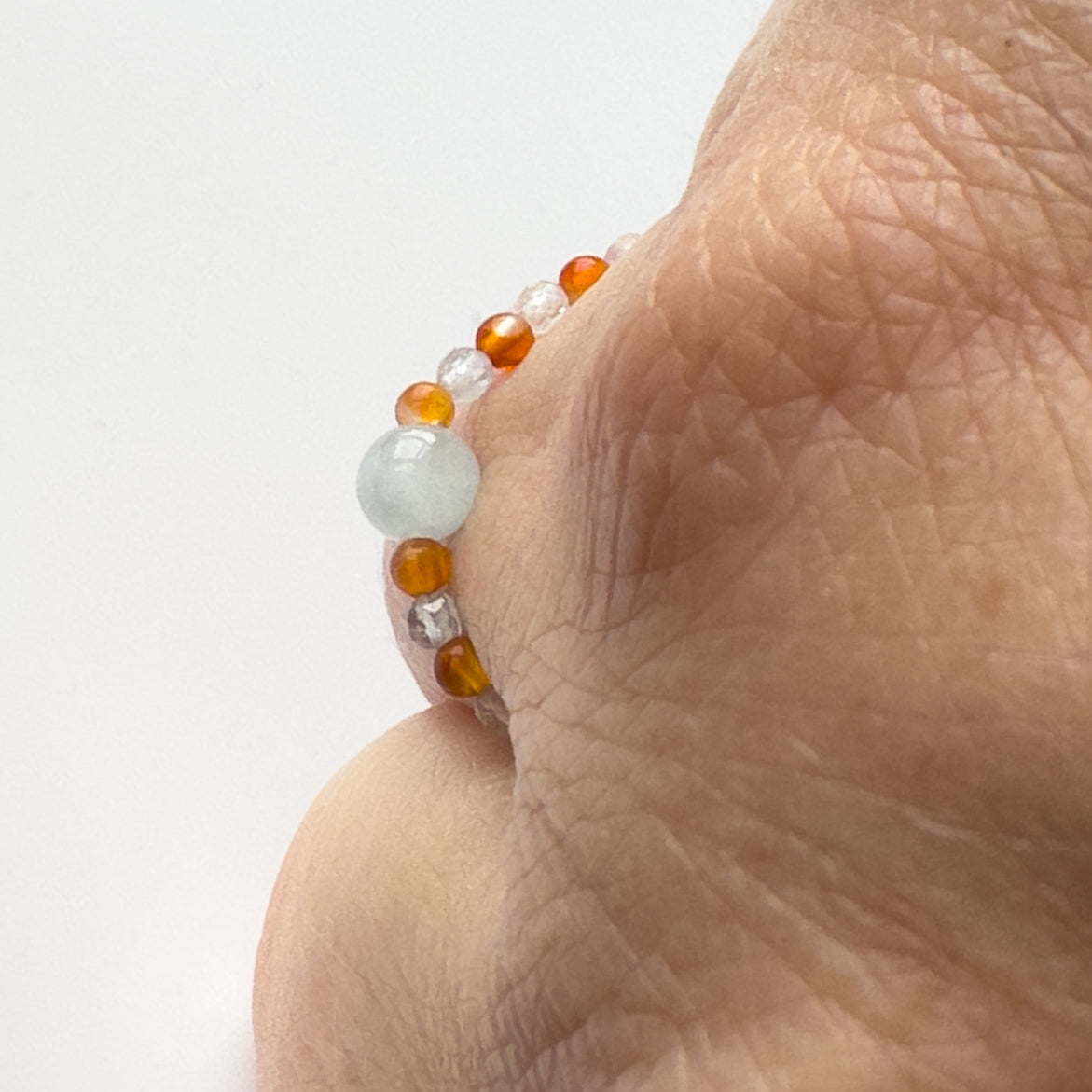 Profile view of Courage Birthstone Healing Crystal ring for Taurus or Aries on finger