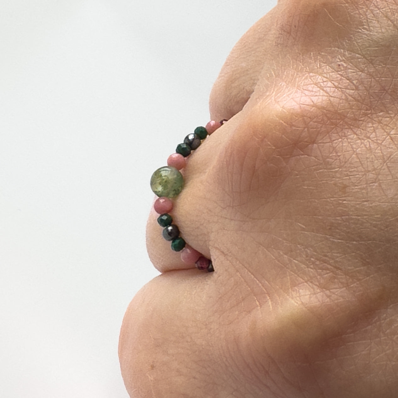 Profile view of Scorpio birthstone Healing Crystal ring for Love and Compassion on finger