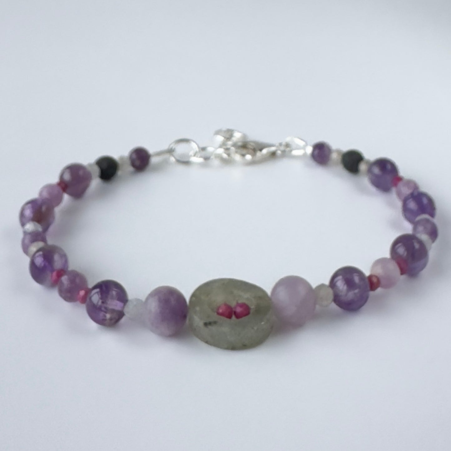 Multi-coloured beaded bracelet on white bacground