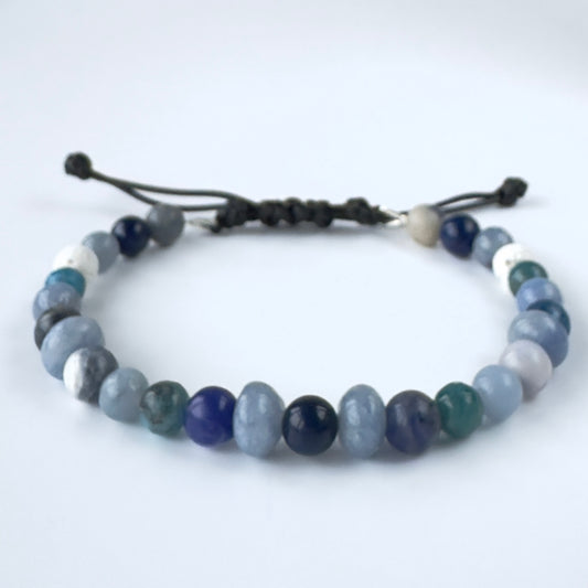 Beaded bracelet with blue and white stones on a white background