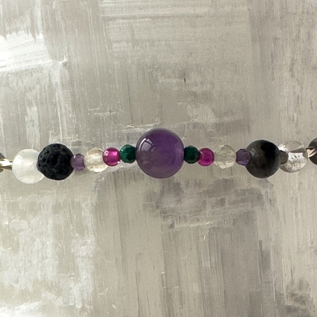 Scorpio birthstone Healing Crystal bracelet for Grief & Loss support showing Citrine, Malachite, Labradorite, Ruby, Amethyst, Selenite, Clear Quartz and Lava Stone