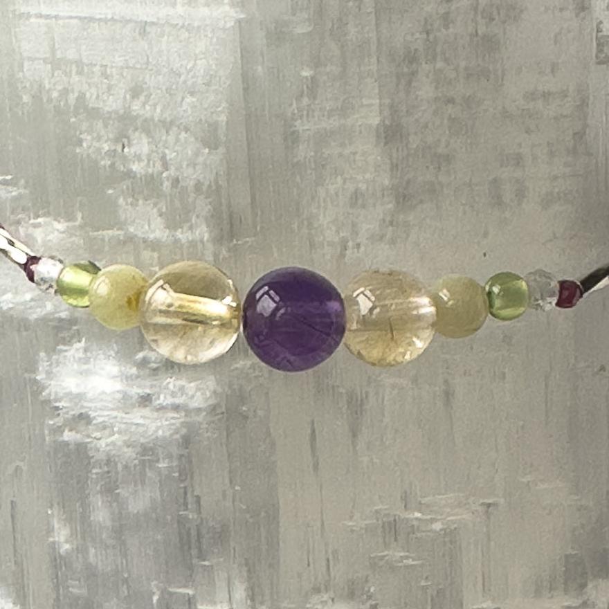 Scorpio Birthstone Healing Crystal bracelet for Determination & Willpower showing Amethyst, Citrine, Aragonite, Garnet, Peridot and Clear Quartz