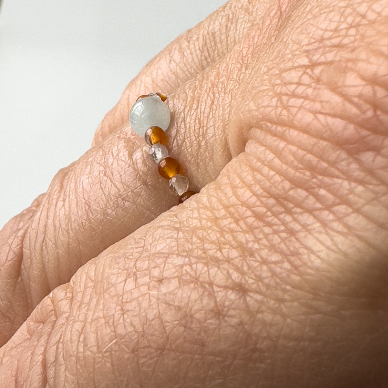 Side view of Courage Birthstone Healing Crystal ring for Taurus or Aries on finger