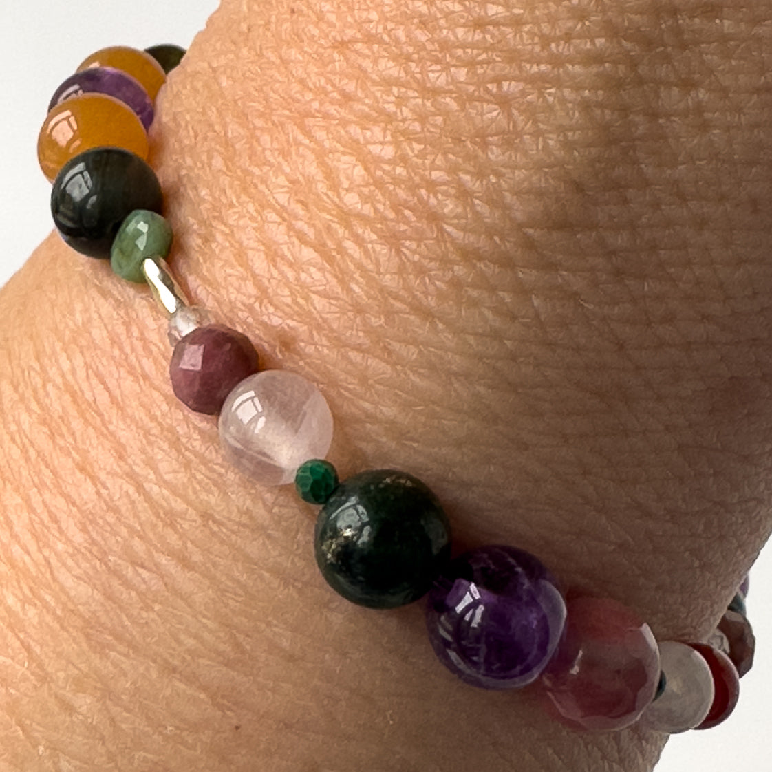 Taurus Birthstone Healing Crystal bracelet for Grief & Loss support on wrist showing Amethyst, Malachite, Rhodonite, Rose Quartz, Carnelian and Azurite