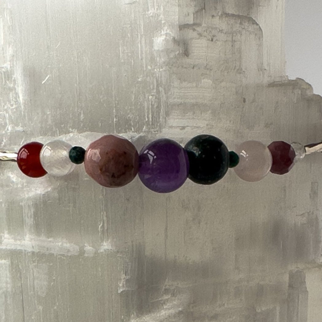 Taurus Birthstone Healing Crystal bracelet for Grief & Loss support showing Amethyst, Malachite, Rhodonite, Rose Quartz, Carnelian, Blue Tiger’s Eye and Selenite