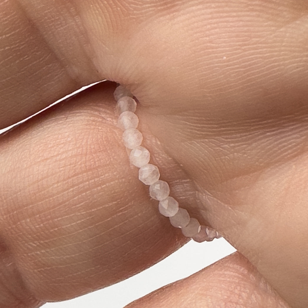 Underside view of Aquarius Birthstone Healing Crystal ring for Love and Compassion on finger