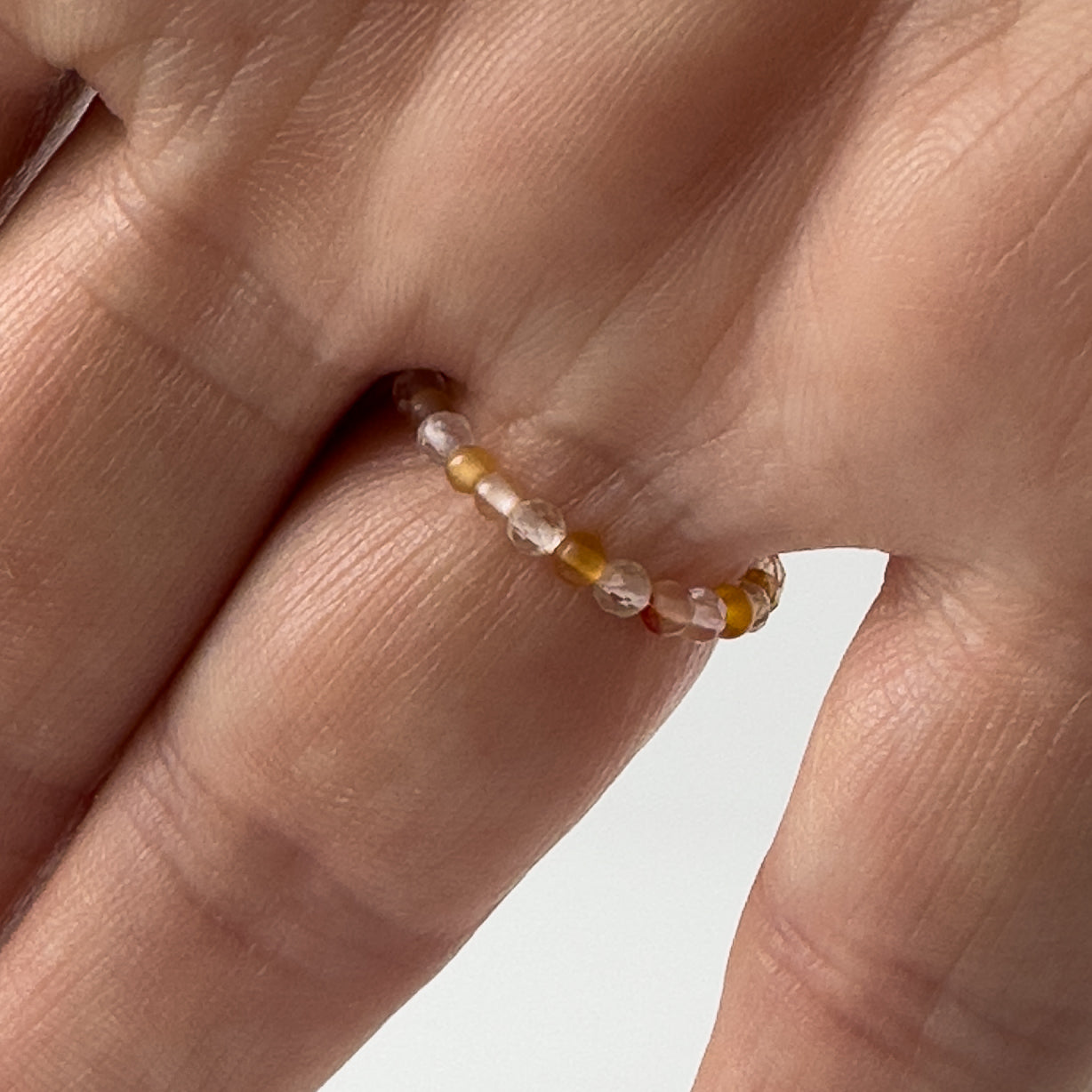 Underside view of Aries birthstone Healing Crystal ring for Strength and Courage on a finger