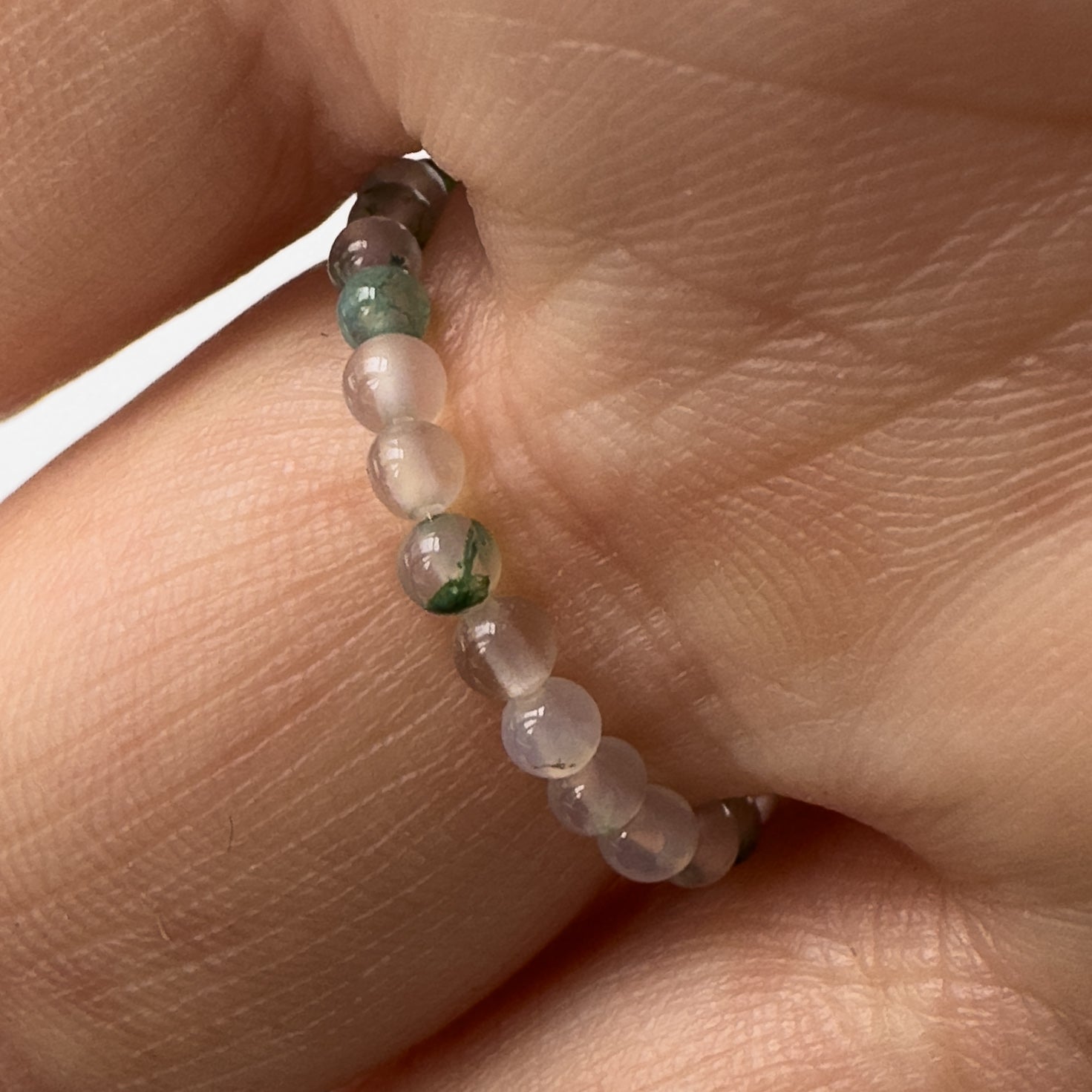 Underside view of Love and Compassion Healing Crystal ring for Capricorn or Scorpio on finger