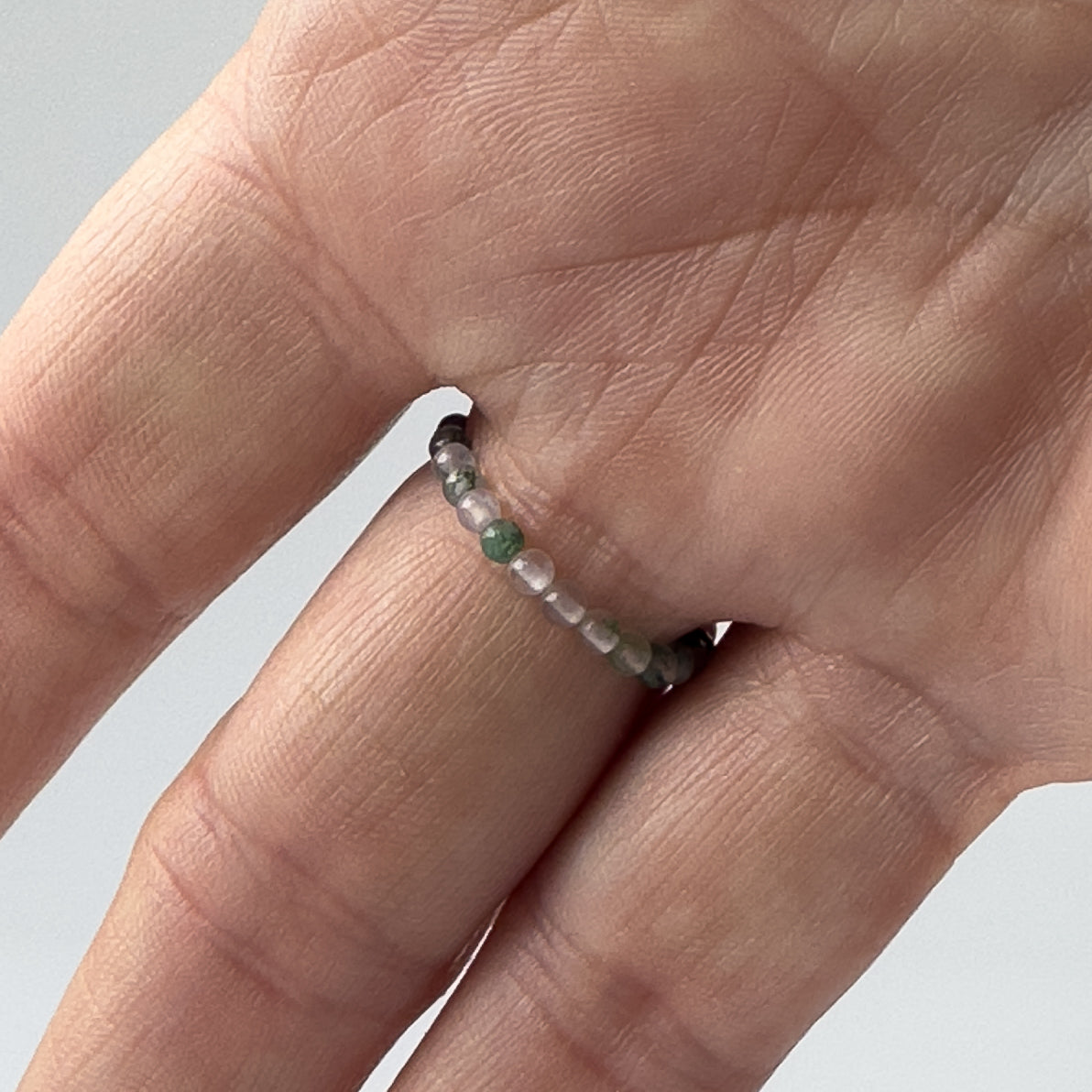 Underside view of Scorpio birthstone Healing Crystal ring for Love and compassion on finger