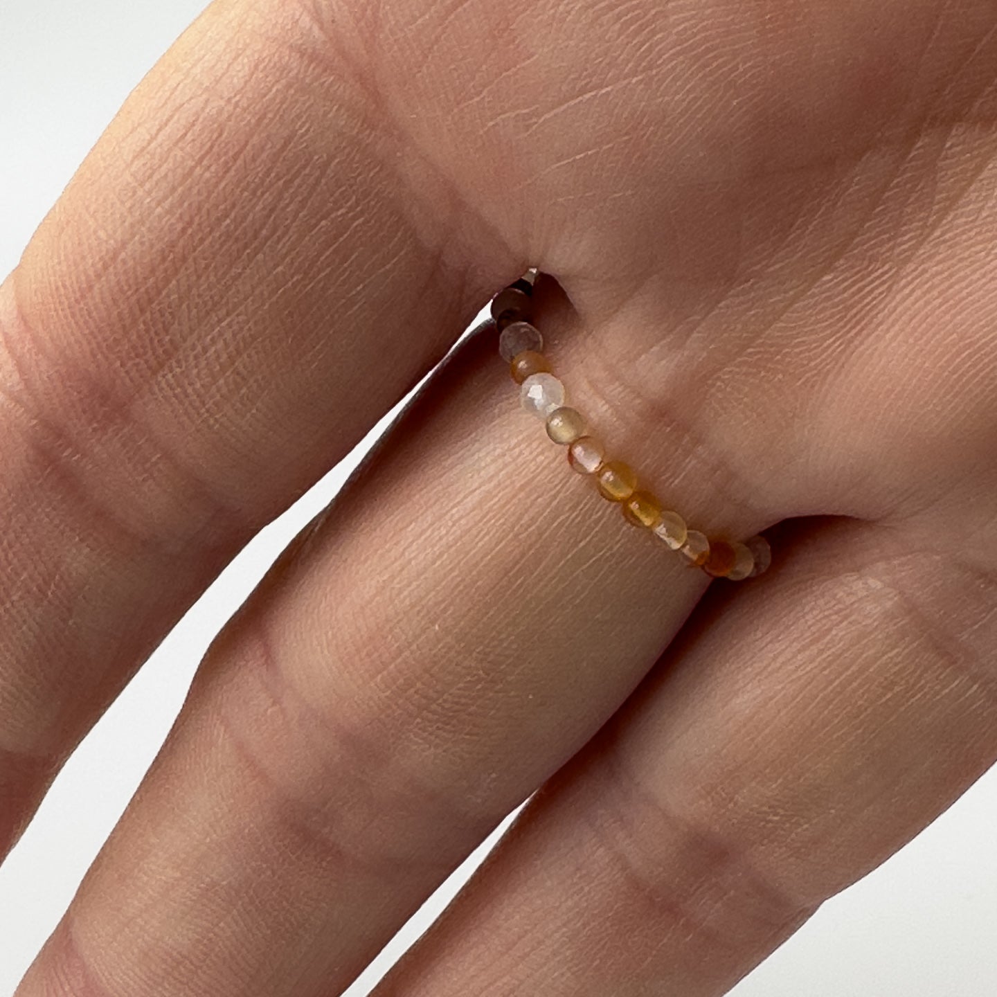 Underside view of Virgo Birthstone Healing Crystal ring for Strength and Courage on finger