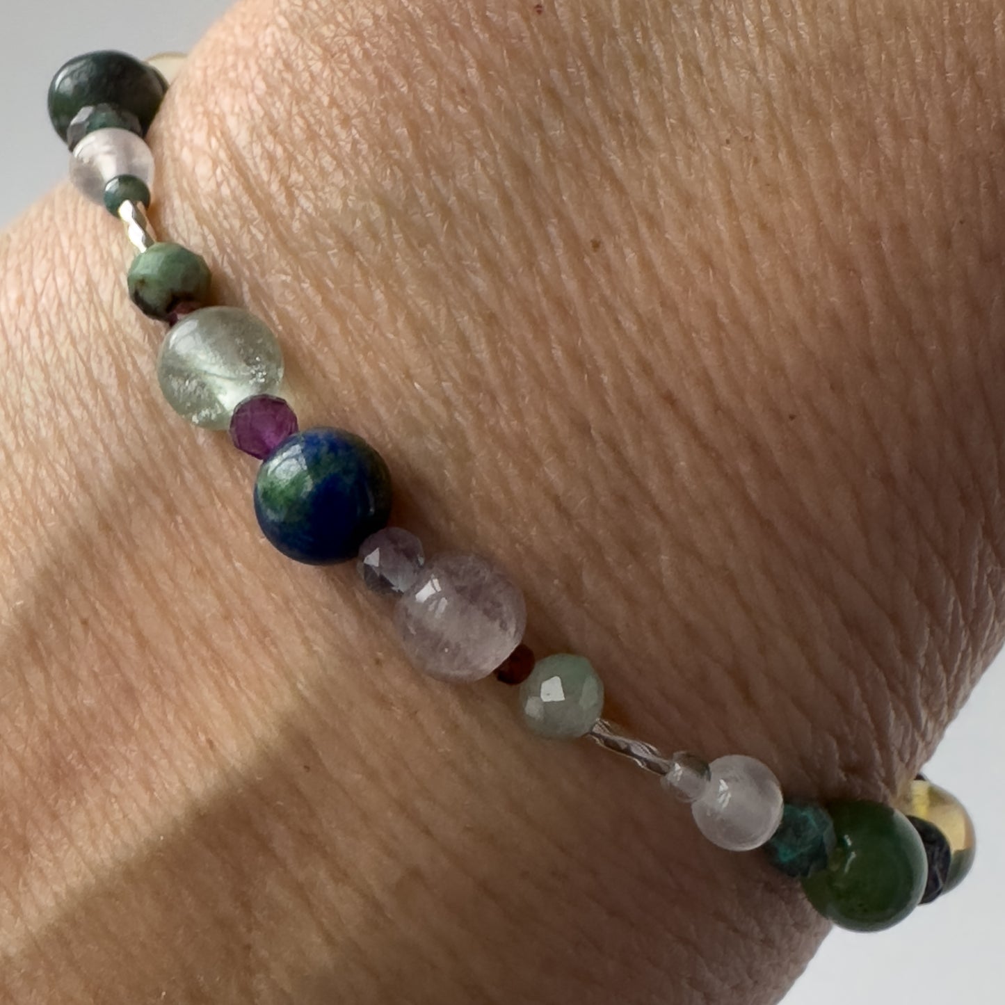 Virgo Healing Crystal bracelet for Confidence on wrist showing Chrysocolla, Fluorite, Purple Fluorite and Garnet