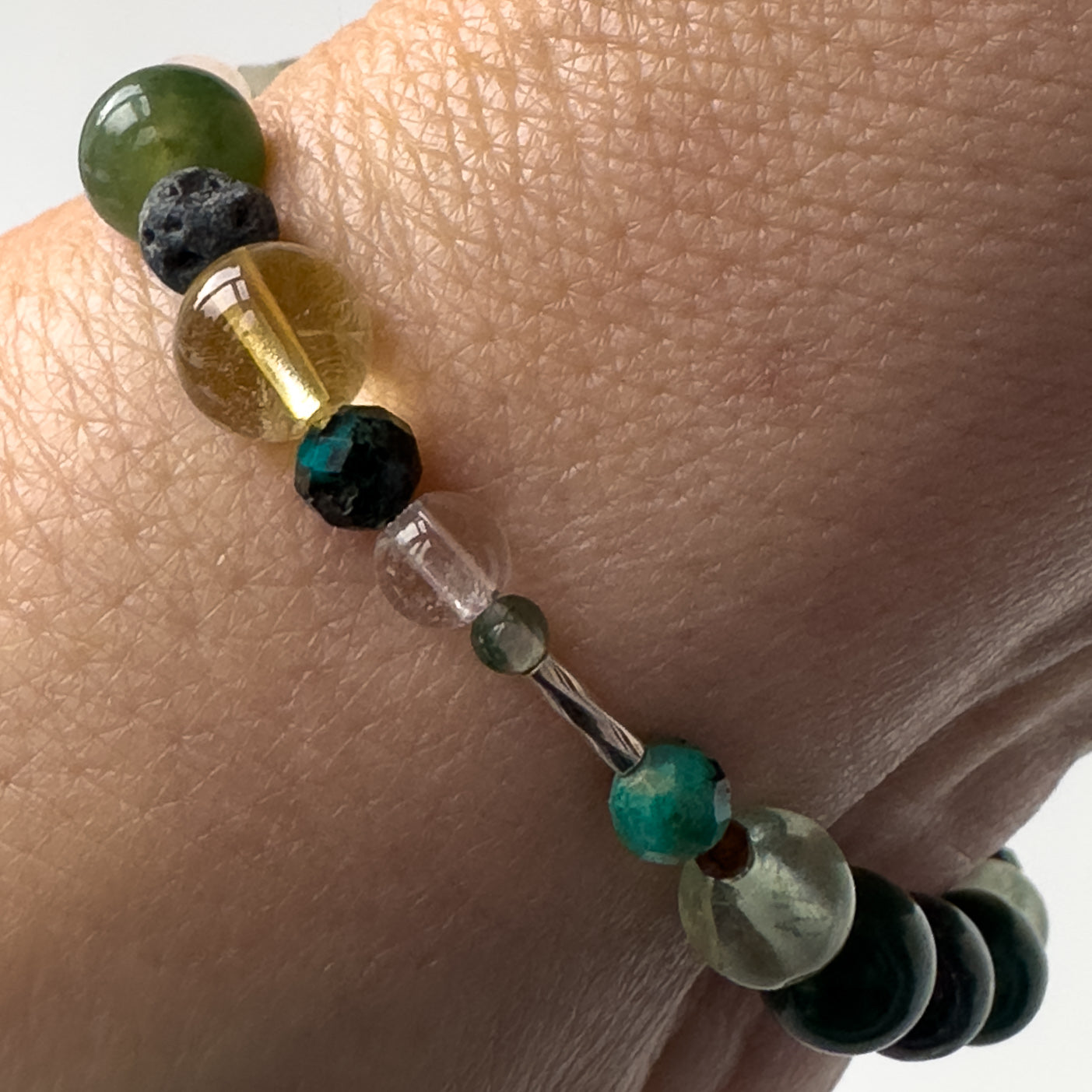 Virgo Birthstone Healing Crystal bracelet for Confidence and Self-esteem on wrist showing Citrine, Moss Agate, Chrysocolla, Fluorite, Garnet, Clear Quartz and Lava Stone