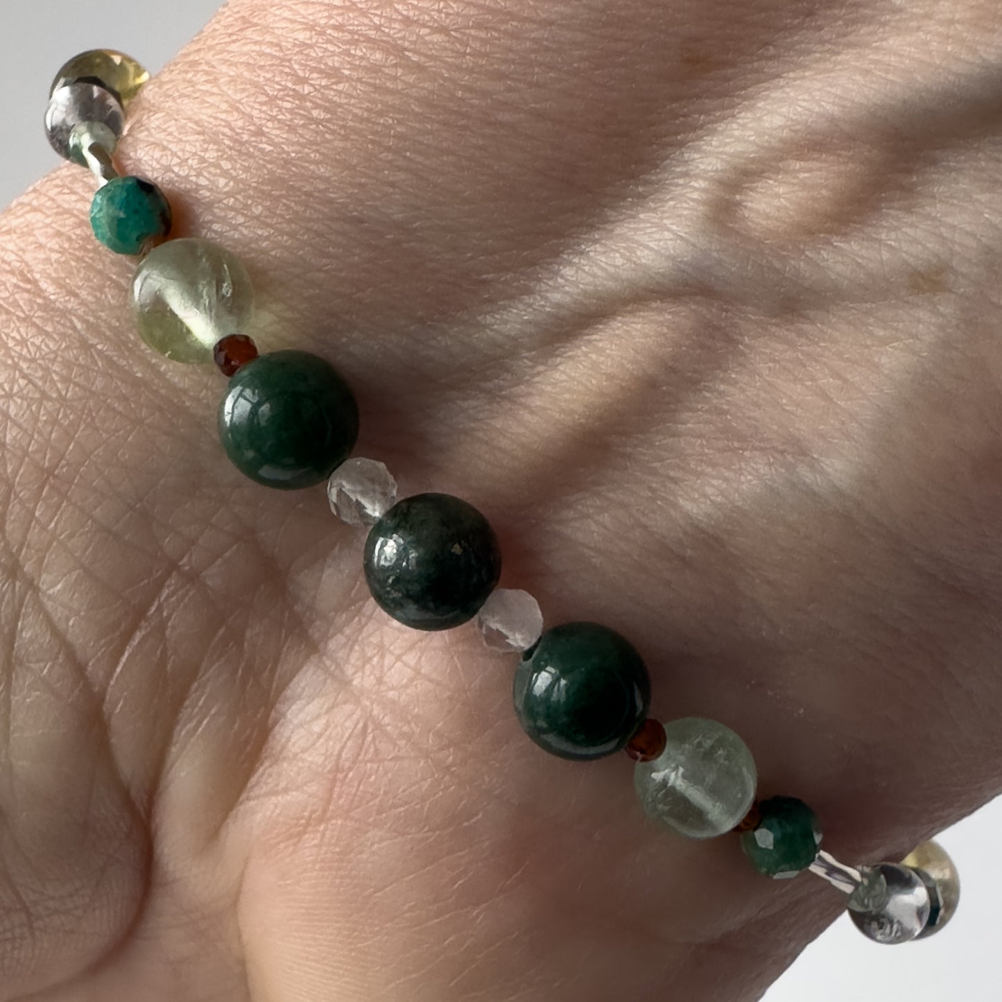 Virgo Birthstone Healing Crystal bracelet for Confidence and Self-esteem on wrist showing Moss Agate, Chrysocolla, Fluorite and Garnet