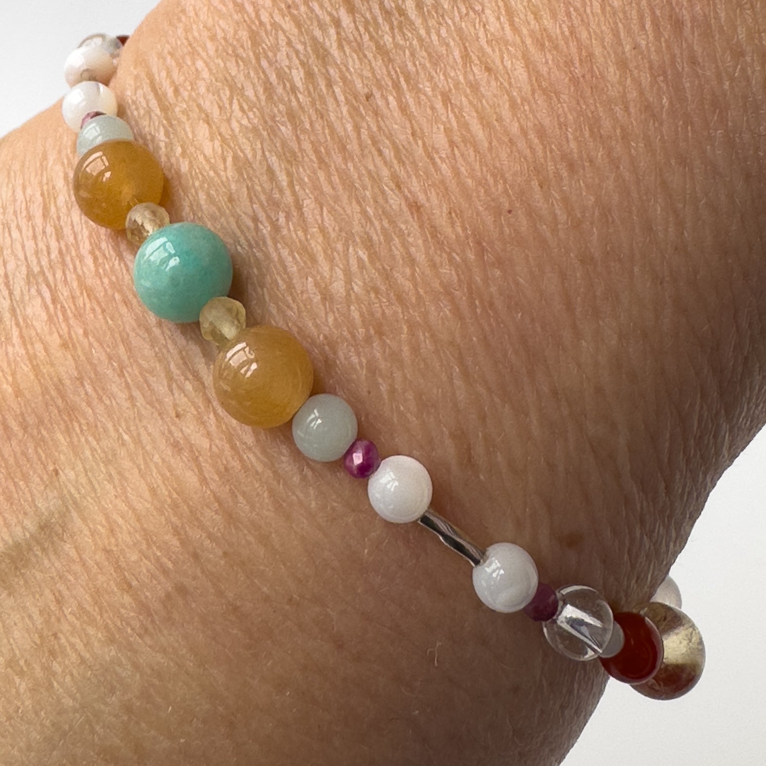 Virgo Healing Crystal bracelet for Grief & Loss on wrist showing Carnelian, Amazonite, Citrine, Sugilite and Moonstone