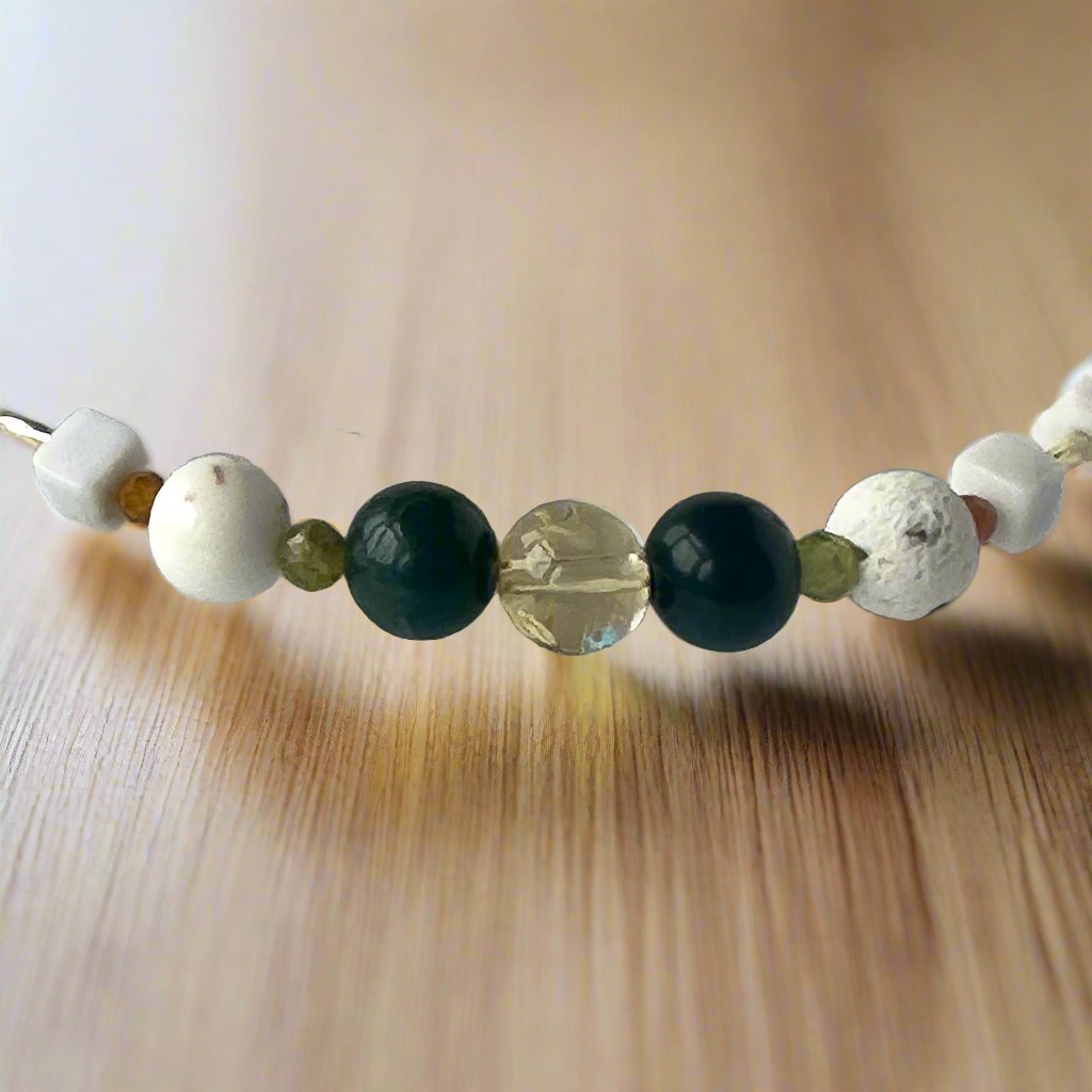 Virgo Birthstone Healing Crystal bracelet for Love and Compassion showing Citrine, Peridot, Moss Agate, Garnet, Howlite, Magnesite and Lava Stone