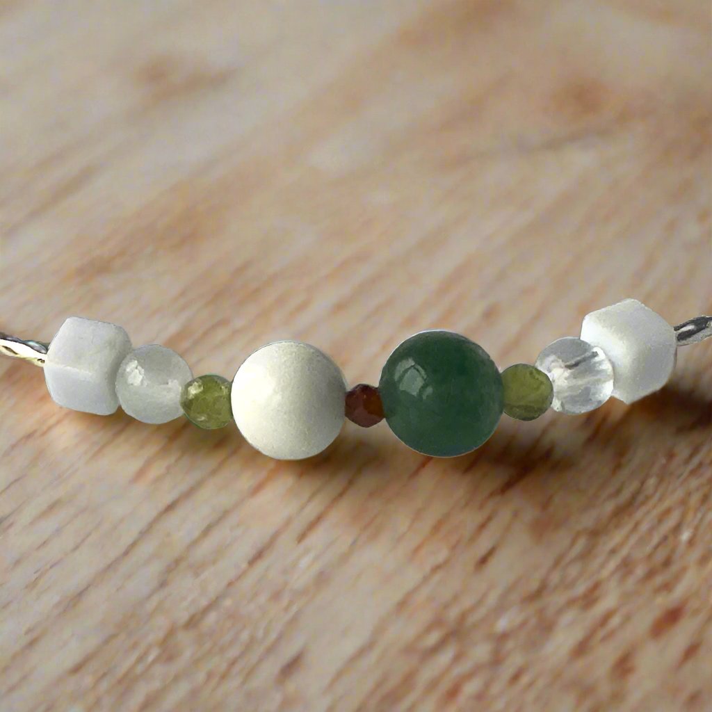 Virgo Birthstone Healing Crystal bracelet for Love and Compassion showing Peridot, Moss Agate, Garnet, Howlite, Magnesite, Selenite and Clear Quartz